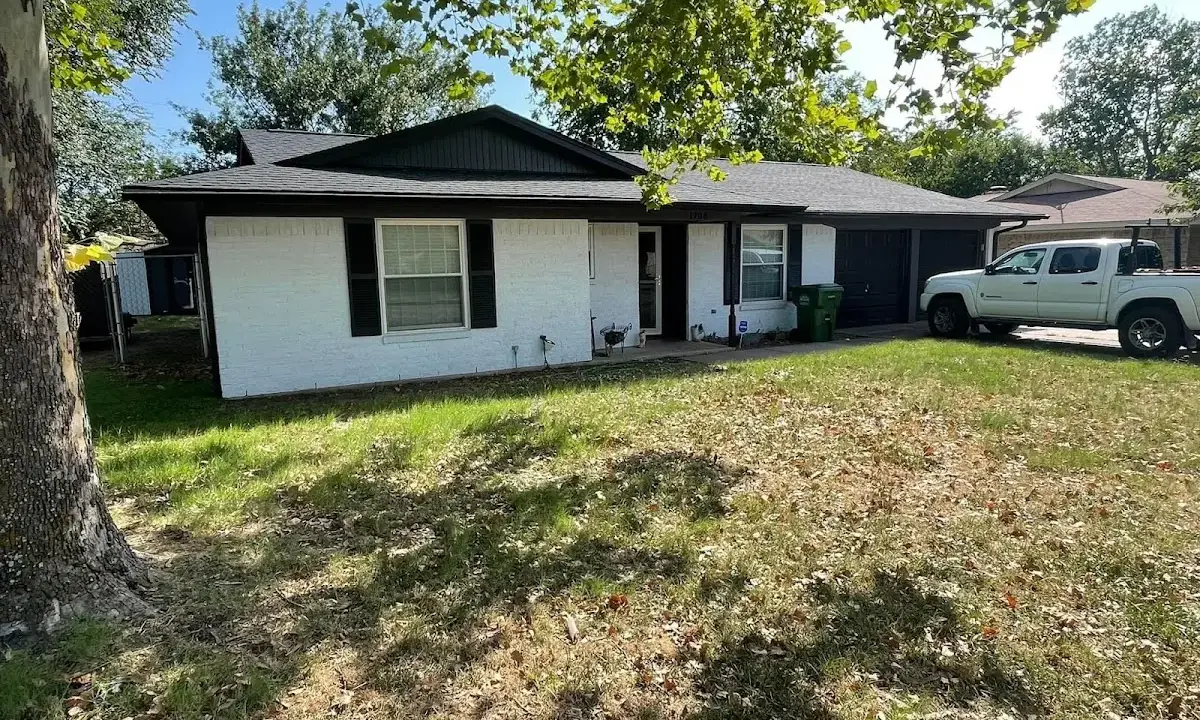Professional roofing crew working on a residential roof in East Riverdale
